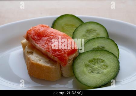 Open sandwiches with salmon, butter, white bread and cucumbers. Stock Photo