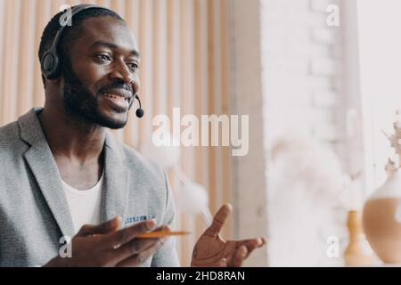 African american freelancer in headset having video call on laptop at ...