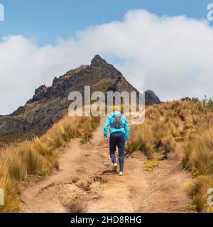 Tourist walking the high altitude Rucu Pichincha volcano hike with backpack in the Andes mountains, Pichincha Volcano, Quito, Ecuador. Stock Photo