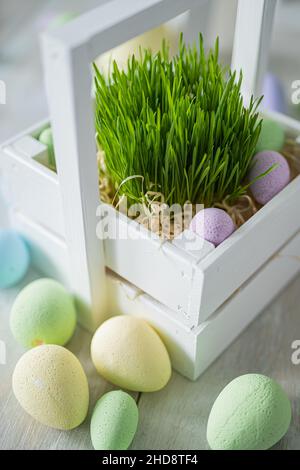 Flower composition with easter colorful dyed eggs in white wooden box. Easter composition. Stock Photo