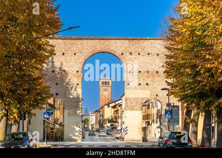 Cherasco, Cuneo, Italy - October 27, 2021: Via Vittorio Emanuele seen from the Arch of Narzole Gate (18th century) with the civic tower and arch of th Stock Photo