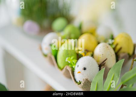Flower composition with easter colorful dyed eggs, happy easter. Easter composition. Stock Photo