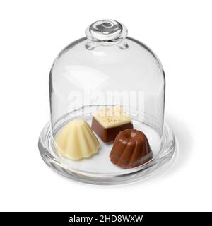 Variation of chocolate bonbons in a glass bell jar display close up Stock Photo