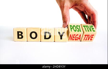 Body positive or negative symbol. Psychologist turns cubes, changes words body negative to body positive. Beautiful white background, copy space. Psyc Stock Photo