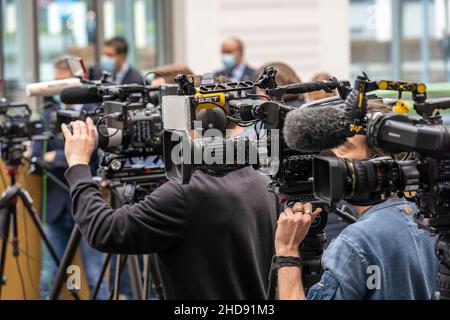 Media, cameras from different broadcasters at a press conference, at Corona time, cameramen with mouth-nose protection mask, Germany Stock Photo