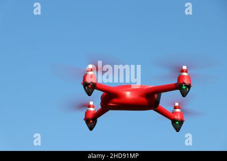 Red drone on a blue sky background. High quality photo Stock Photo