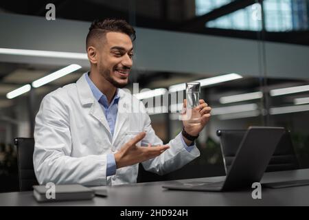 Handsome young muslim scientist using laptop at office Stock Photo