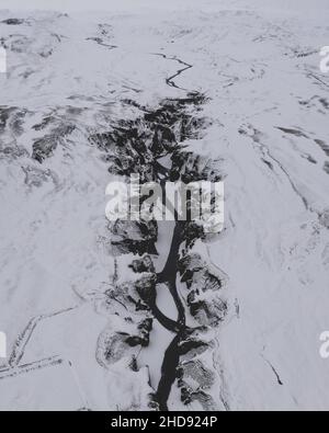 Aerial view of a snowy land with a frozen river Stock Photo - Alamy