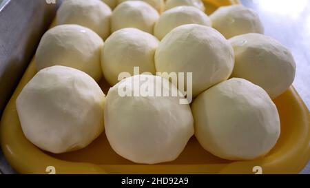 Homemade butter on a tray. Production of butter on an industrial scale. Butter in the shape of a ball. Stock Photo