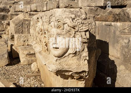 fragment of a frieze with stone mask on the ruins of the ancient city of Mira, Turkey Stock Photo