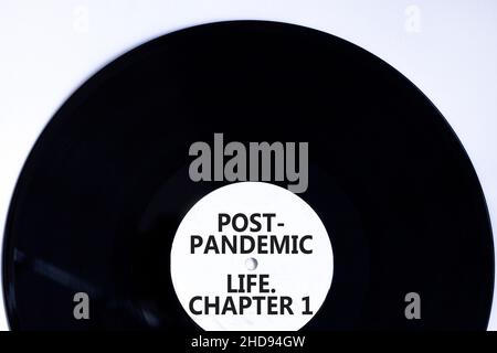 Post-pandemic life chapter 1 symbol. Concept words Post-pandemic life chapter 1 on retro black vinyl disc. Beautiful white background, copy space. Cov Stock Photo