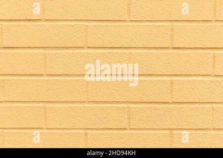 Pastel yellow painted brick wall texture background. Stock Photo