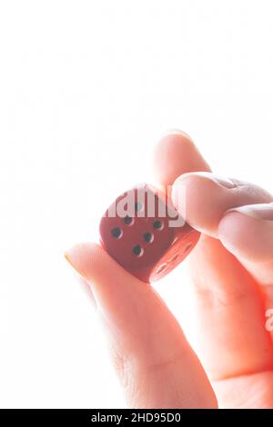 Red dice in a hand on a white background Stock Photo