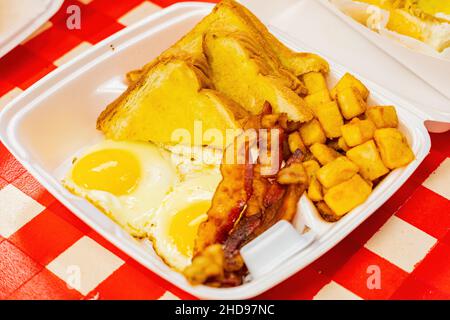 Close up of two sunny egg with toast and bacon, potato at New Orleans, Lousiana Stock Photo