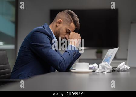 Upset middle eastern manager looking for creative solutions Stock Photo