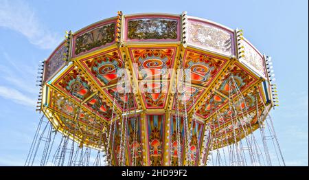 A bright and colourful fairground Chair-O-Plane attraction in a park in London, England, U.K. Stock Photo