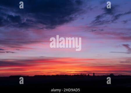 A colorful sunset sky on the prairies near Winkler, Manitoba, Canada. Stock Photo