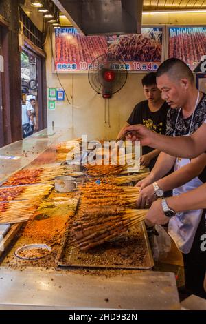 CHONGQING, CHINA - AUGUST 17, 2018: Meat skewer stall in Ciqikou Ancient Town, China Stock Photo