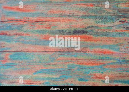 Textured wooden background - grungy weathered wooden surface covered with old blue and red peeling paint Stock Photo