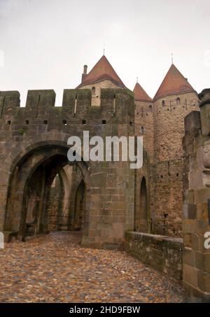 The Narbonne Gate is a crenellated arched entrance to the citadel of Cité de Carcassonne in France. Stock Photo