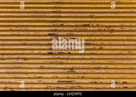Old, yellow painted, rusted metal plate background. rustic top view background Stock Photo