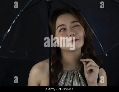 Portrait of a cute and beautiful young woman from Vietnam with an umbrella Stock Photo