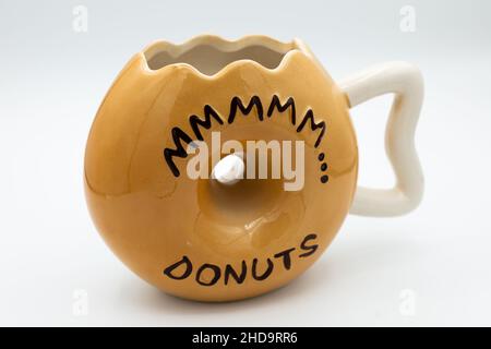 Close-up shot of a cute donut-shaped mug isolated on a white background Stock Photo