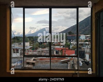 Volcano seen from a window in Guatemala Stock Photo