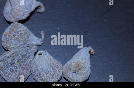 Various dried figs on black slate tray Stock Photo