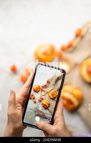 Food photo on smartphone. Smartphone in women's hands. Stock Photo