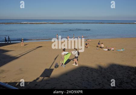 People swimming, playing sports, surfing, eating and drinking at Las Canteras beach in Las Palmas, Gran Canaria, Canary Islands,Spain Stock Photo