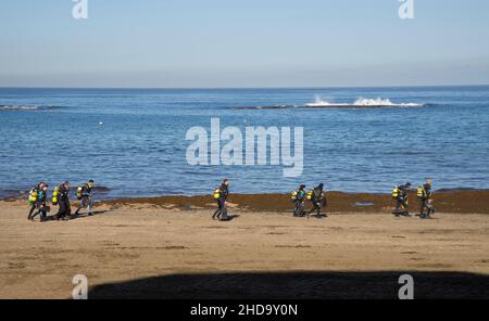 People swimming, playing sports, surfing, eating and drinking at Las Canteras beach in Las Palmas, Gran Canaria, Canary Islands,Spain Stock Photo