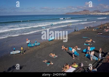 People swimming, playing sports, surfing, eating and drinking at Las Canteras beach in Las Palmas, Gran Canaria, Canary Islands,Spain Stock Photo