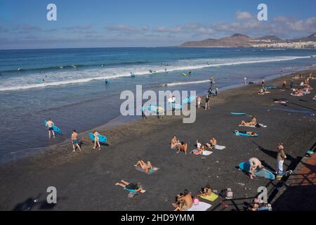 People swimming, playing sports, surfing, eating and drinking at Las Canteras beach in Las Palmas, Gran Canaria, Canary Islands,Spain Stock Photo