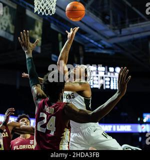 Winston-Salem, NC, USA. 4th Jan, 2022. Florida State Seminoles center Naheem McLeod (24) lets Wake Forest Demon Deacons guard Alondes Williams (31) shoot a layup during the first half of the ACC Basketball matchup at LJVM Coliseum in Winston-Salem, NC. (Scott Kinser/Cal Sport Media). Credit: csm/Alamy Live News Stock Photo