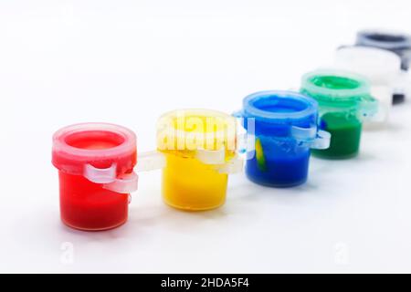 small cans of acrylic paint in a row Stock Photo