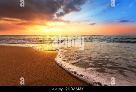 Fiery and dramatic sunset across the lake in summer . Stock Photo