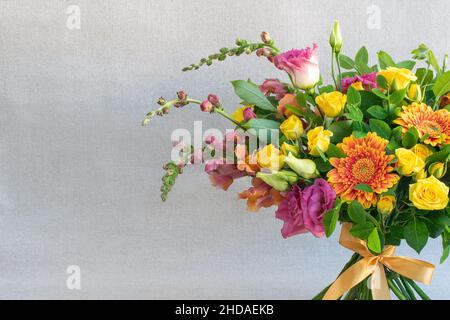 Bright bouquet of decorative and wild flowers on light background Stock Photo