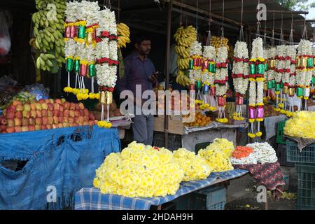 December 20, 2021, Colorful garlands flower selling in the market stalls in Karnataka, India, These flowers are used for wedding decorations, temple c Stock Photo