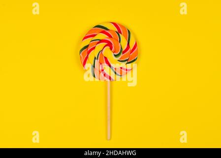 Colorful candy on a yellow  background. Lollipop. Top view. Copy space. Stock Photo