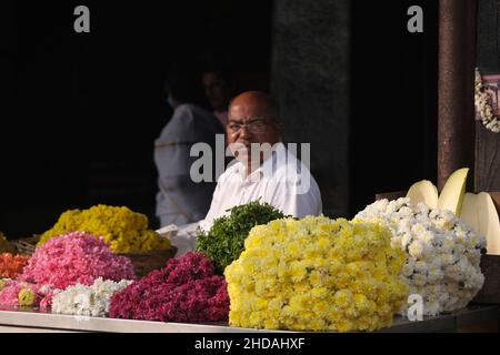 December 20, 2021, Colorful garlands flower selling in the market stalls in Karnataka, India, These flowers are used for wedding decorations, temple c Stock Photo