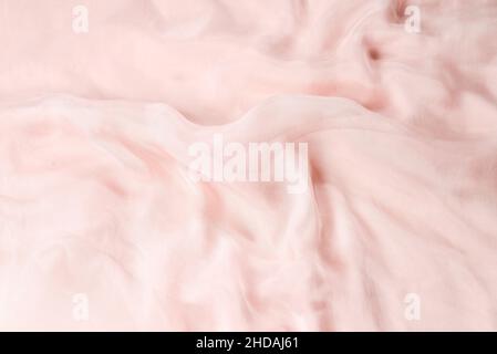 Soft smooth pink silk fabric background. Fabric texture. Stock Photo