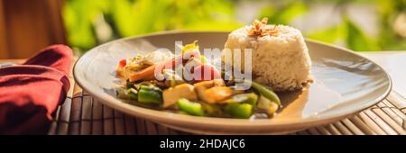 Traditional Balinese cuisine. Vegetable and tofu stir-fry with rice BANNER, long format Stock Photo
