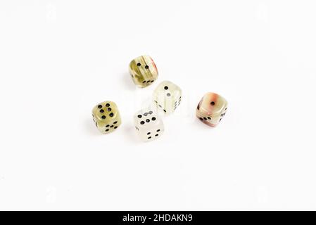 Dices made of natural stone on a white background. Copy space. Gaming. Stock Photo