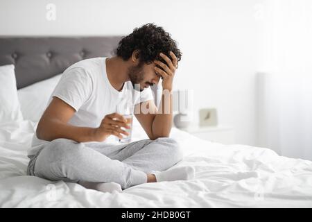 Sick hindu guy feeling bad in the morning Stock Photo