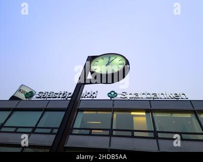 Turku, Finland - December 21, 2021: High Angle View of Saastopankki Bank that Provides Internet Services with the Downtown Clock in Foreground. Stock Photo