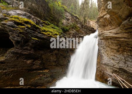 A waterfall cuts it's way though Johnston Canyon  in Banff National Park, Canada Stock Photo