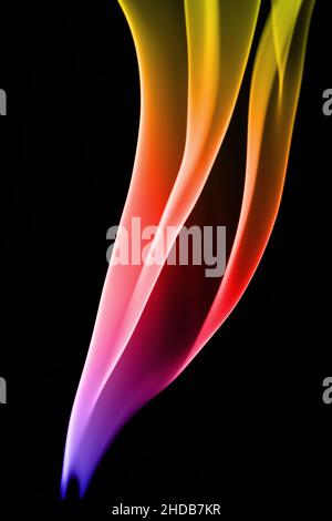 Pretty flame coloured patterns made by incense smoke trails Stock Photo