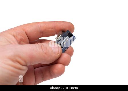 a pad with a chip, a microchip with copper contacts in a person hand on an isolated pure white background and an empty space for inserting text Stock Photo