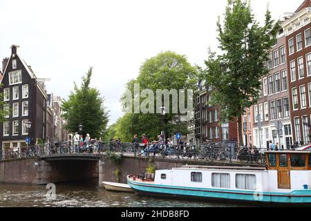 Pedestrian walkway and road above a Canal underpass on the Canals of Amsterdam. Stock Photo